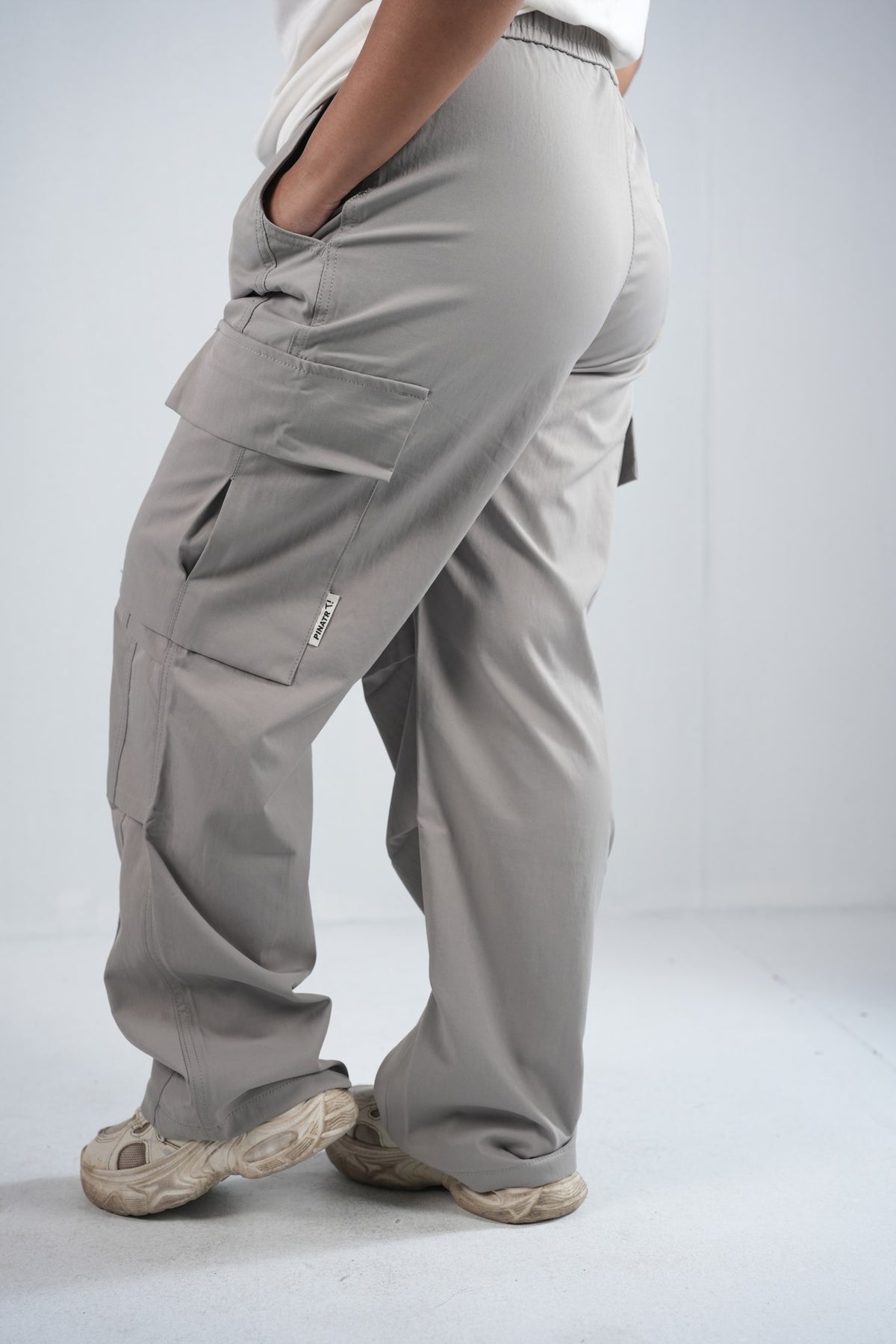 Premium Cargo Pant For Men & Women – Stone Grey, side view on model | BYSPORTS