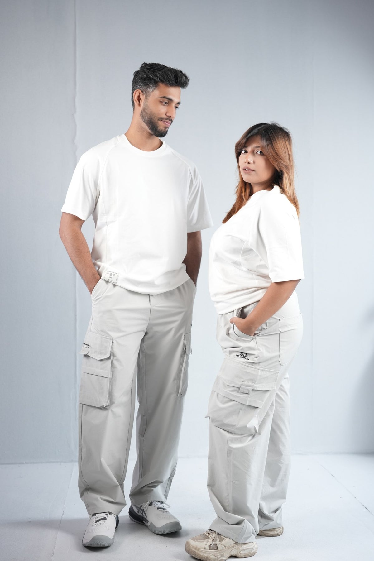 Premium Multi-Pocket Cargo Pant For Men & Women – Light Grey, worn by male and female models 4 | BYSPORTS