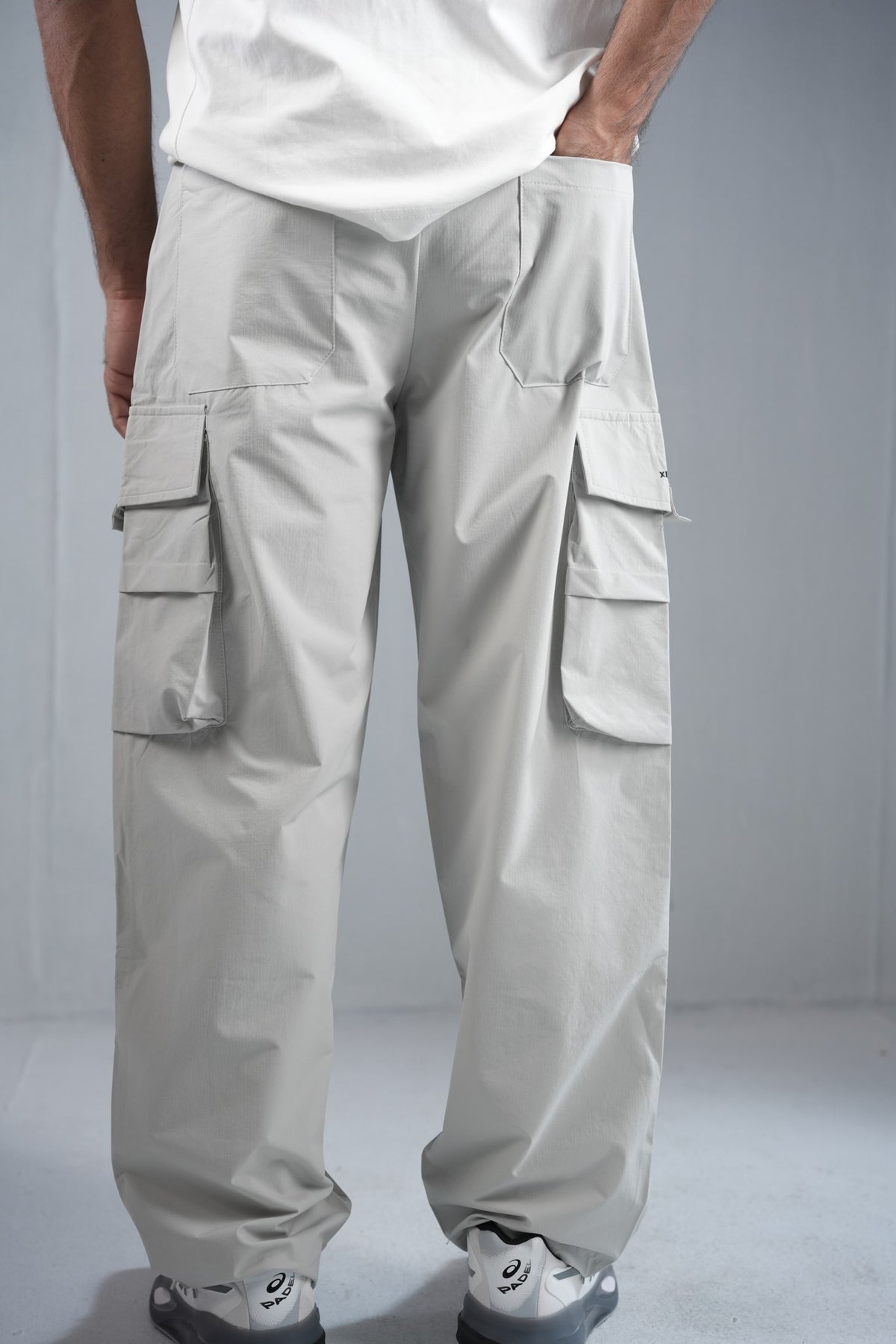 Premium Multi-Pocket Cargo Pant For Men & Women – Light Grey, side view on model | BYSPORTS