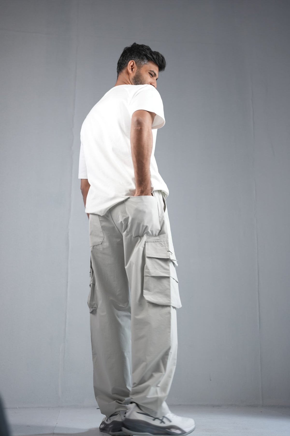 Premium Multi-Pocket Cargo Pant For Men & Women – Light Grey, side view on model 2 | BYSPORTS