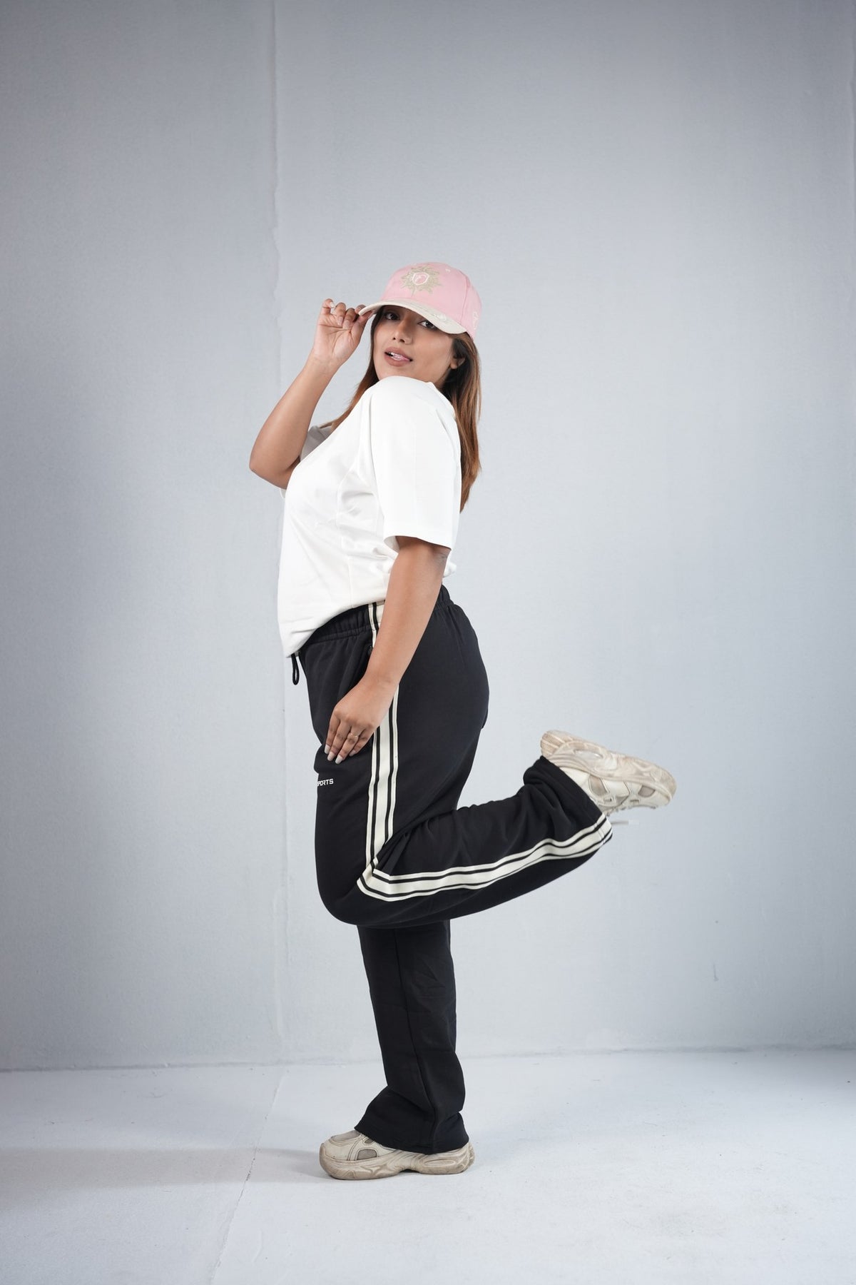 BYSPORTS Premium Side-Stripe Trouser For Men & Women – Black, lifestyle shot on model 6 | BYSPORTS