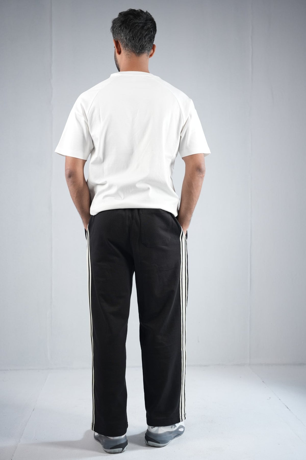 BYSPORTS Premium Side-Stripe Trouser For Men & Women – Black, worn by model 4 | BYSPORTS