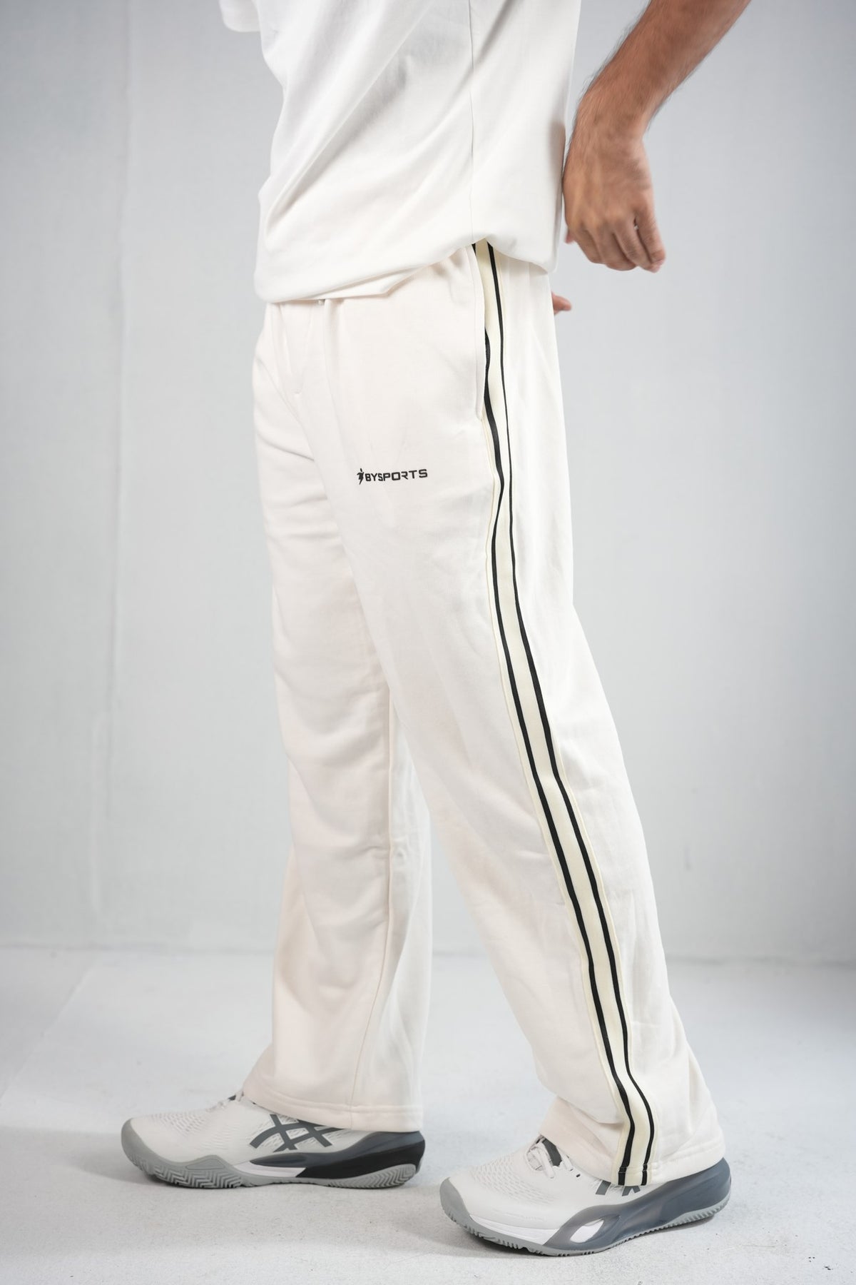 BYSPORTS Premium Side-Stripe Trouser For Men & Women – Cream, side view on model 2 | BYSPORTS
