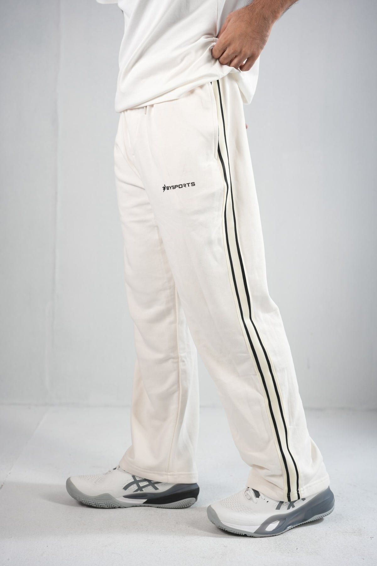 BYSPORTS Premium Side-Stripe Trouser For Men & Women – Cream, side view on model 3 | BYSPORTS